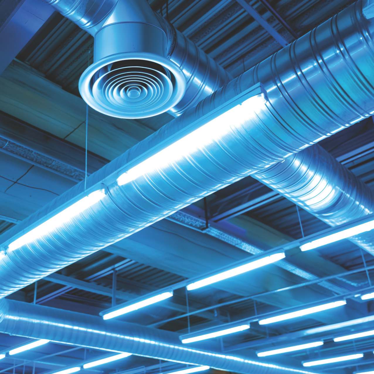 HVAC engineer performing annual maintenance inspection on commercial AC system